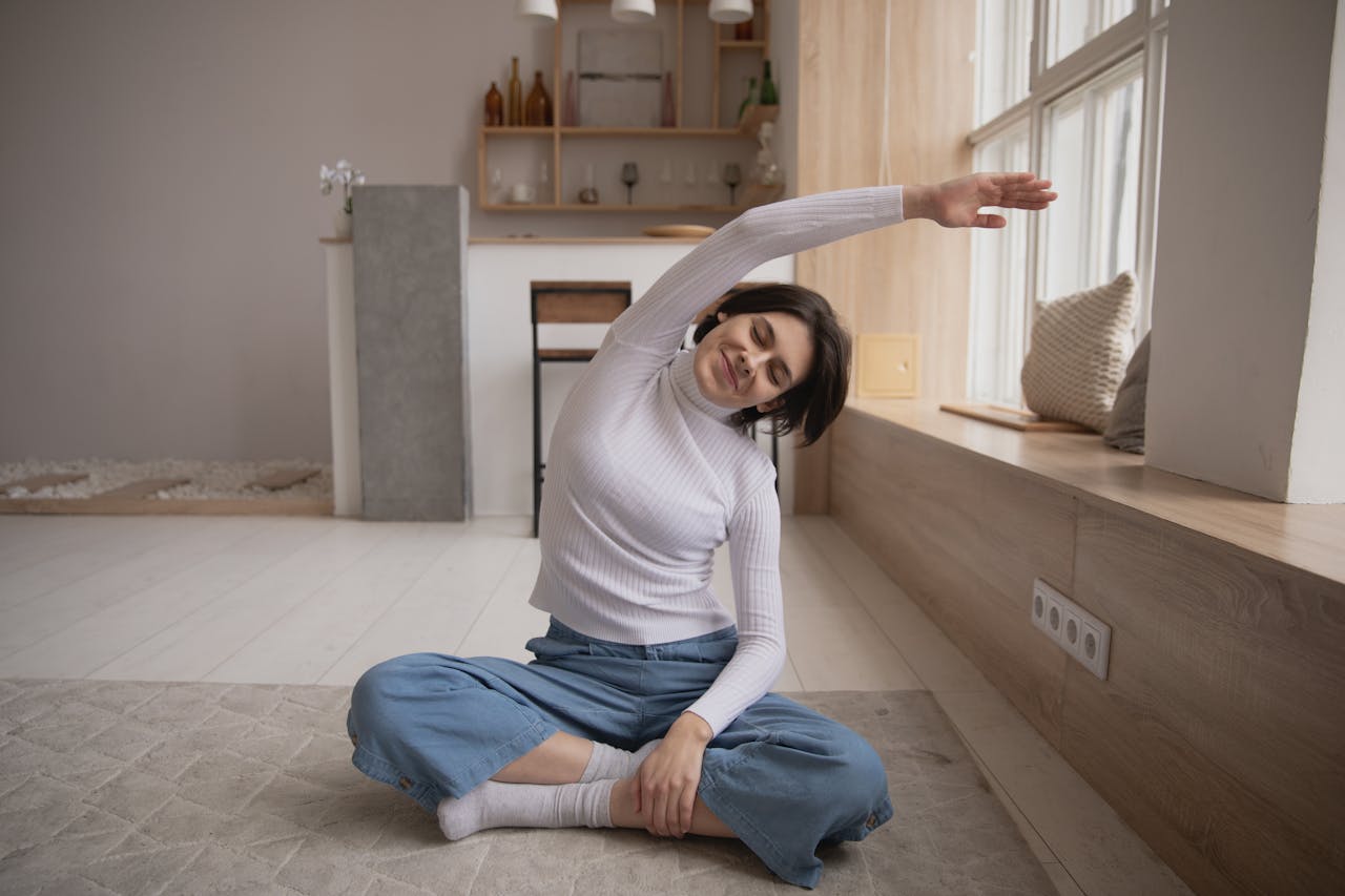 smiling-woman-practicing-yoga-with-closed-eyes-at-home